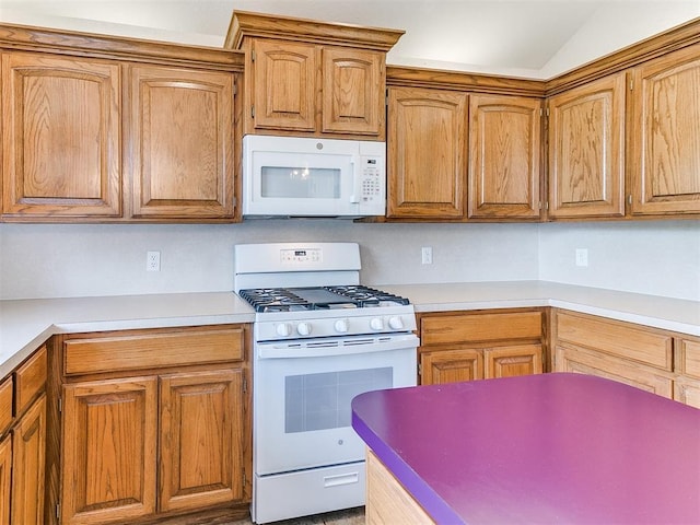 1512 Selborne Pl, Yukon, OK 73099 - kitchen with white appliances, light countertops, lofted ceiling, and brown cabinets