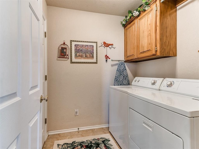1512 Selborne Pl, Yukon, OK 73099 - laundry area featuring cabinet space, washer and clothes dryer, baseboards, and light tile patterned flooring