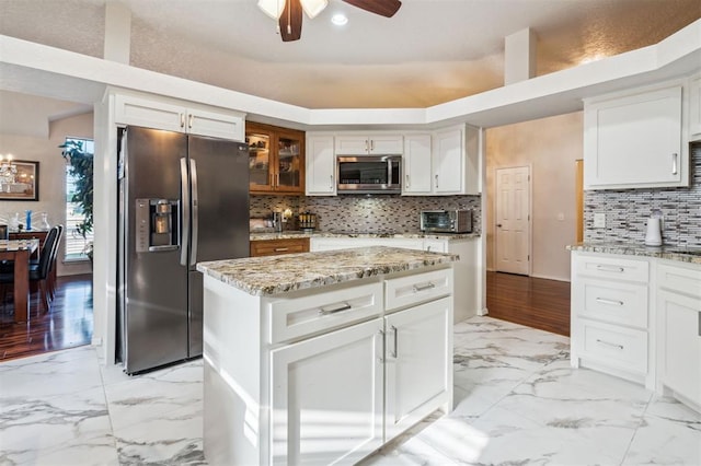 1721 Park View Pl, Edmond, OK 73003 - kitchen featuring stainless steel appliances, light marble finish flooring, a ceiling fan, and light stone countertops