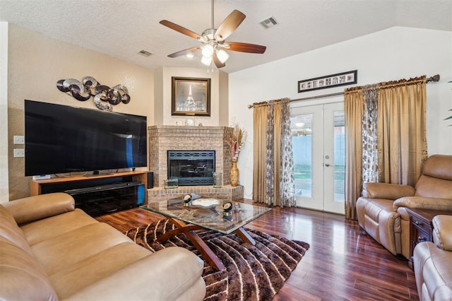 1721 Park View Pl, Edmond, OK 73003 - living area with wood finished floors, a ceiling fan, a fireplace, and french doors