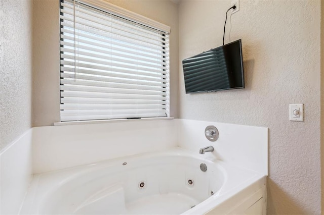 1721 Park View Pl, Edmond, OK 73003 - full bath with a textured wall and a jetted tub