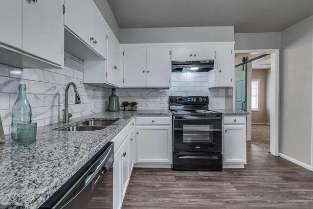 4017 Mallard Dr, Oklahoma City, OK 73115 - kitchen with black appliances, a sink, under cabinet range hood, light stone countertops, and white cabinets