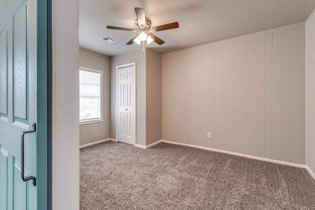 4017 Mallard Dr, Oklahoma City, OK 73115 - empty room with carpet, a ceiling fan, and baseboards