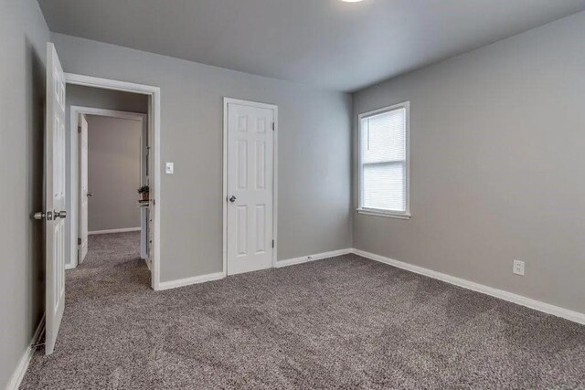 4017 Mallard Dr, Oklahoma City, OK 73115 - unfurnished bedroom with carpet floors and baseboards