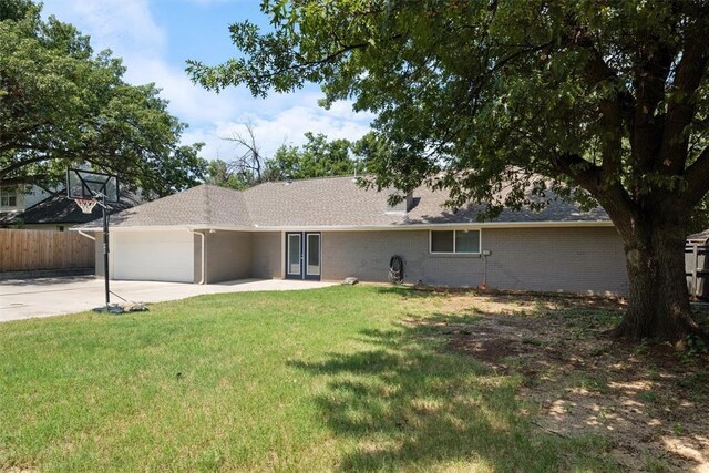 3004 Robin Ridge Rd, Oklahoma City, OK 73120 - view of front of home with a garage, concrete driveway, brick siding, a shingled roof, and french doors