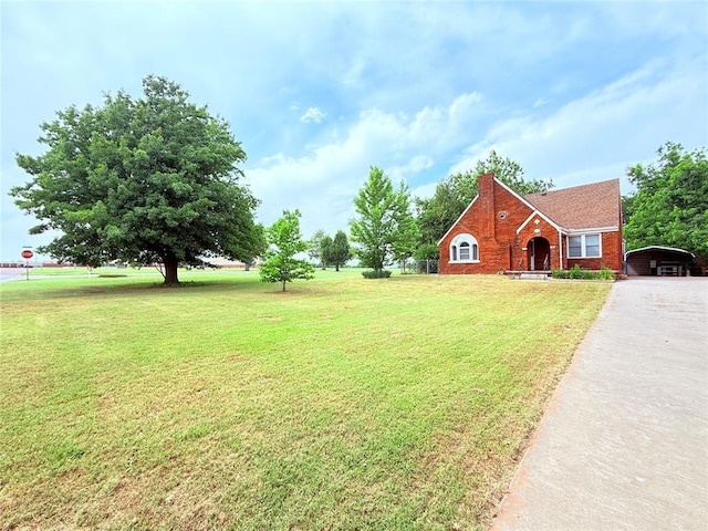 1710 W Chickasha Ave, Chickasha, OK 73018 - view of green lawn with a carport and driveway
