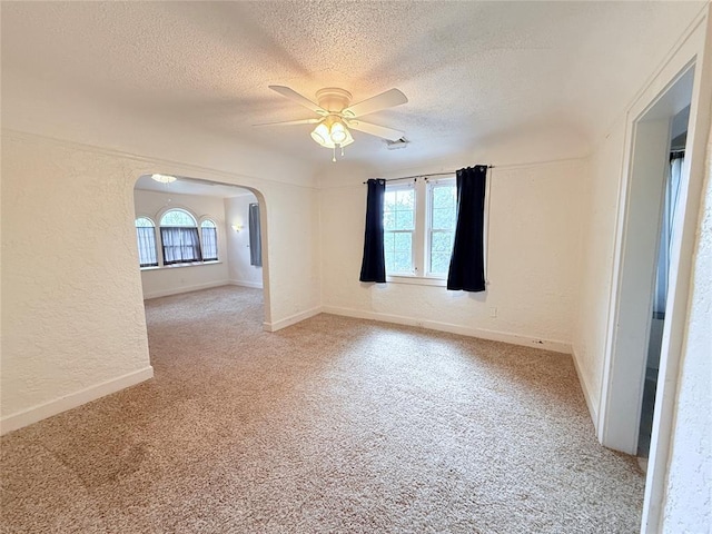 1710 W Chickasha Ave, Chickasha, OK 73018 - unfurnished room featuring a textured ceiling, a ceiling fan, light carpet, plenty of natural light, and a textured wall