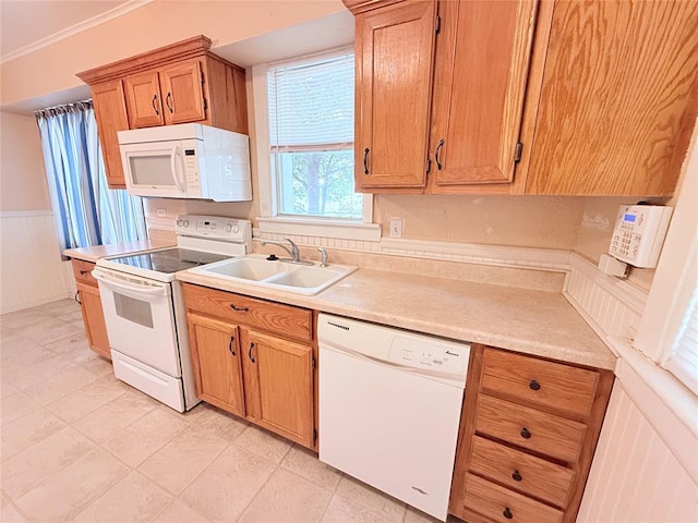 1710 W Chickasha Ave, Chickasha, OK 73018 - kitchen with white appliances, a sink, a wainscoted wall, light countertops, and ornamental molding