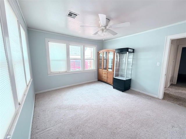 1710 W Chickasha Ave, Chickasha, OK 73018 - unfurnished bedroom with light colored carpet, baseboards, crown molding, and ceiling fan