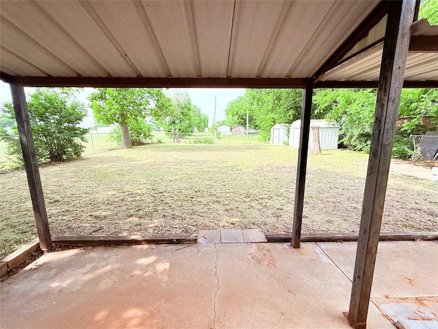1710 W Chickasha Ave, Chickasha, OK 73018 - view of yard featuring a patio, a storage shed, a carport, and an outbuilding