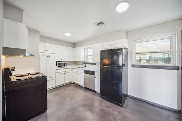 kitchen featuring appliances with stainless steel finishes, concrete flooring, a sink, white cabinetry, and light countertops