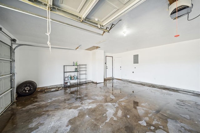 garage with a garage door opener and electric panel