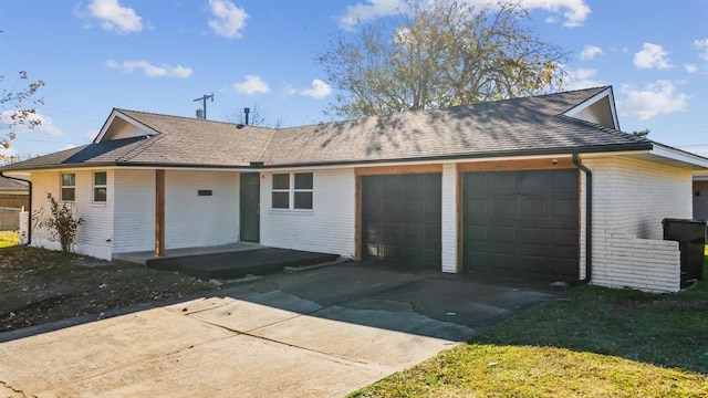 ranch-style house featuring an attached garage, brick siding, concrete driveway, and covered porch