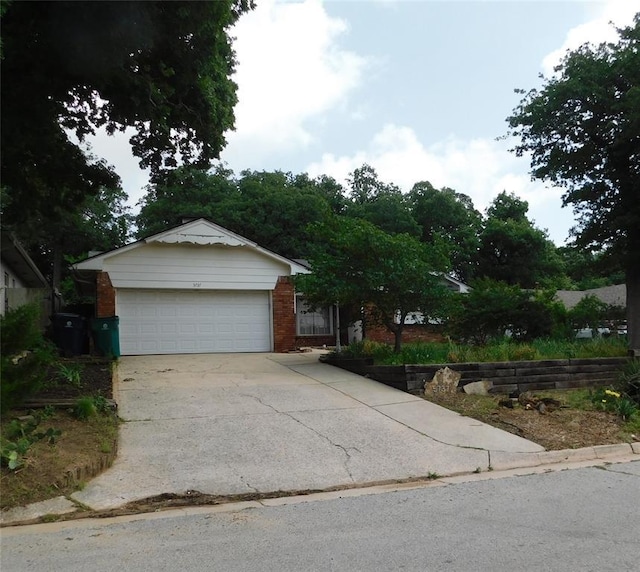 5737 NW 31st St, Oklahoma City, OK 73122 - ranch-style home featuring brick siding and concrete driveway