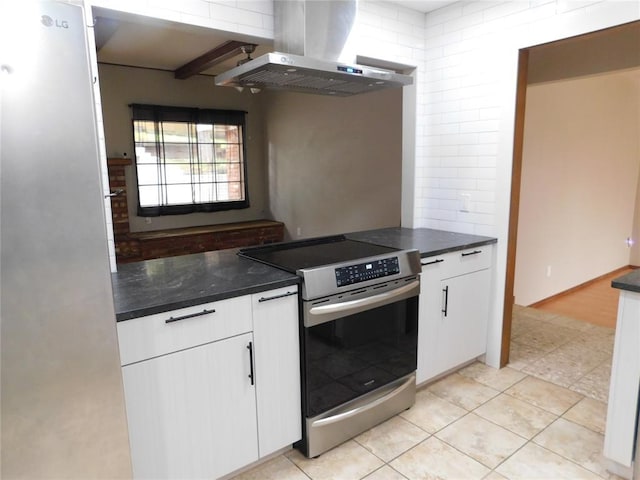 5737 NW 31st St, Oklahoma City, OK 73122 - kitchen featuring stainless steel electric stove, ventilation hood, white cabinetry, and light tile patterned floors