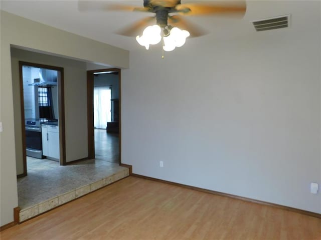 5737 NW 31st St, Oklahoma City, OK 73122 - empty room featuring light wood finished floors, ceiling fan, and baseboards