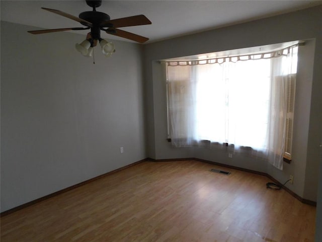 5737 NW 31st St, Oklahoma City, OK 73122 - unfurnished room with healthy amount of natural light, wood finished floors, and ceiling fan