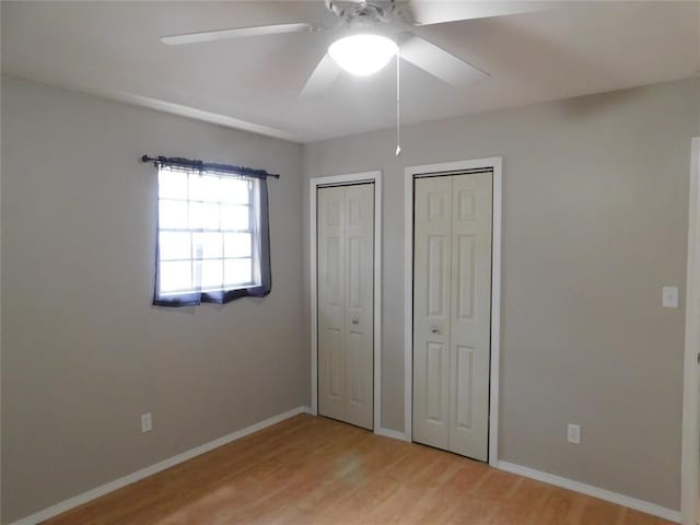 5737 NW 31st St, Oklahoma City, OK 73122 - unfurnished bedroom with light wood finished floors, multiple closets, baseboards, and ceiling fan