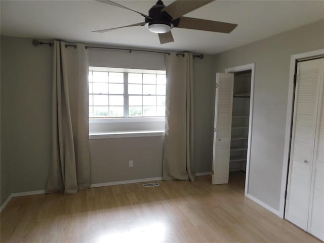 5737 NW 31st St, Oklahoma City, OK 73122 - unfurnished bedroom featuring light wood finished floors, multiple closets, baseboards, and ceiling fan