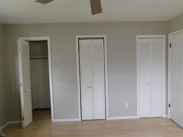 5737 NW 31st St, Oklahoma City, OK 73122 - unfurnished bedroom with multiple closets, light wood finished floors, and baseboards