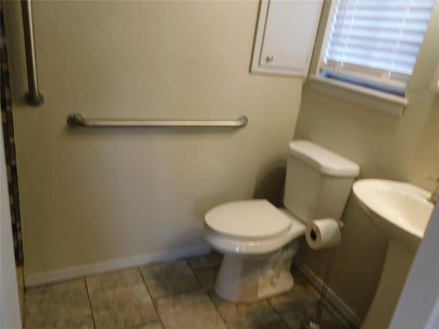 5737 NW 31st St, Oklahoma City, OK 73122 - bathroom featuring baseboards, tile patterned flooring, and toilet