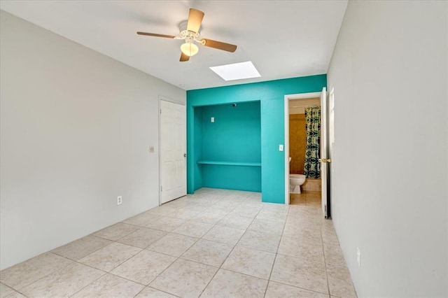 1126 SW 19th St, Oklahoma City, OK 73108 - unfurnished bedroom with a skylight, light tile patterned floors, and a ceiling fan