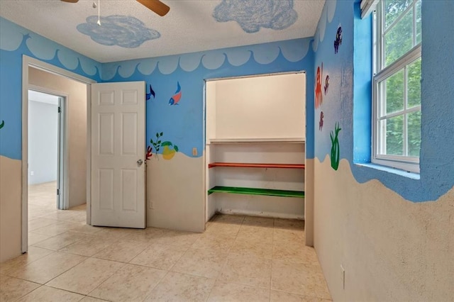 1126 SW 19th St, Oklahoma City, OK 73108 - hall with plenty of natural light, a textured ceiling, and tile patterned floors