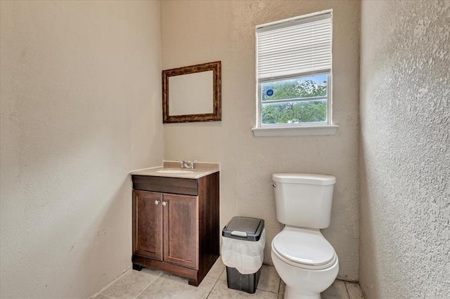 1126 SW 19th St, Oklahoma City, OK 73108 - bathroom with tile patterned floors, toilet, vanity, and a textured wall