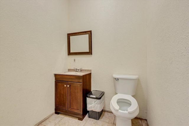 1126 SW 19th St, Oklahoma City, OK 73108 - bathroom with tile patterned flooring, toilet, vanity, and a textured wall