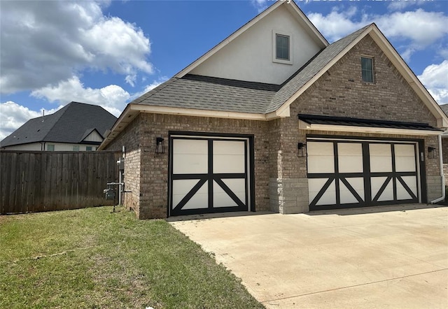 14709 Chambord Dr, Yukon, OK 73099 - view of front of house with brick siding, roof with shingles, a garage, and driveway