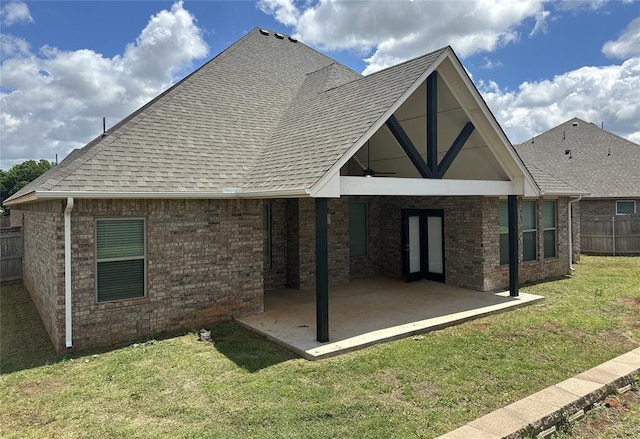 14709 Chambord Dr, Yukon, OK 73099 - rear view of house with a patio area, a shingled roof, and brick siding
