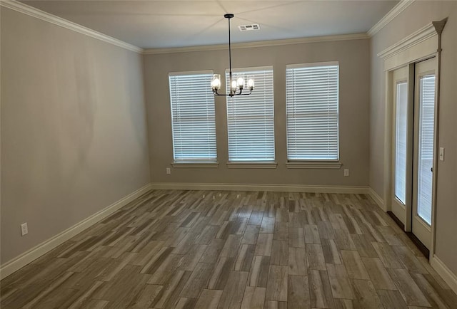 14709 Chambord Dr, Yukon, OK 73099 - unfurnished dining area featuring a chandelier, wood finished floors, baseboards, and crown molding
