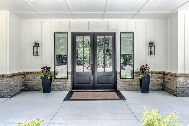 6301 144th Ave NE, Newalla, OK 74857 - property entrance featuring french doors and board and batten siding