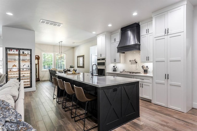 6301 144th Ave NE, Newalla, OK 74857 - kitchen with premium range hood, dark wood finished floors, stainless steel appliances, white cabinetry, and recessed lighting