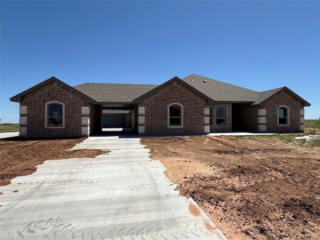 5 Old Glory Ave, Altus, OK 73521 - view of front of property featuring brick siding, a shingled roof, and driveway