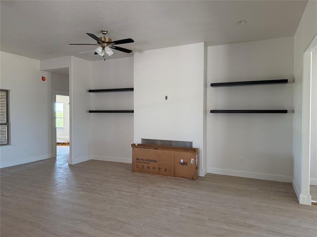 5 Old Glory Ave, Altus, OK 73521 - unfurnished living room with a ceiling fan, baseboards, and wood finished floors