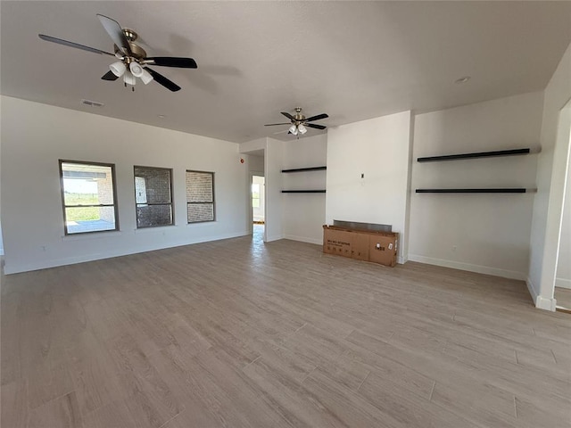 5 Old Glory Ave, Altus, OK 73521 - unfurnished living room featuring baseboards, light wood finished floors, and ceiling fan