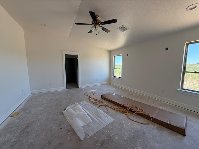 5 Old Glory Ave, Altus, OK 73521 - empty room with a ceiling fan, lofted ceiling, a textured ceiling, baseboards, and concrete floors