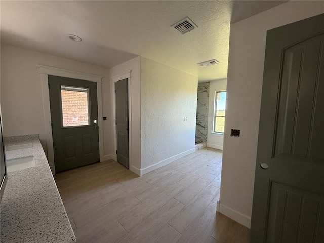 5 Old Glory Ave, Altus, OK 73521 - entrance foyer with light wood-style floors, baseboards, and a textured ceiling