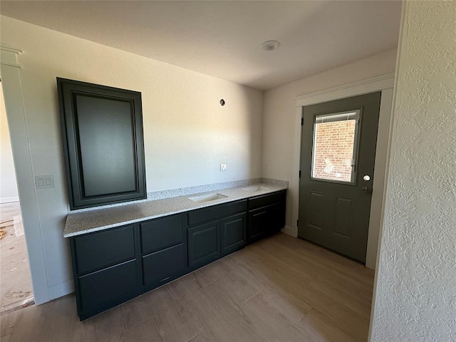 5 Old Glory Ave, Altus, OK 73521 - doorway to outside with wood finished floors, a textured wall, and baseboards