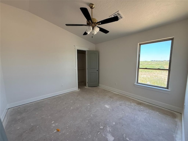5 Old Glory Ave, Altus, OK 73521 - unfurnished bedroom featuring baseboards, lofted ceiling, a ceiling fan, and unfinished concrete floors