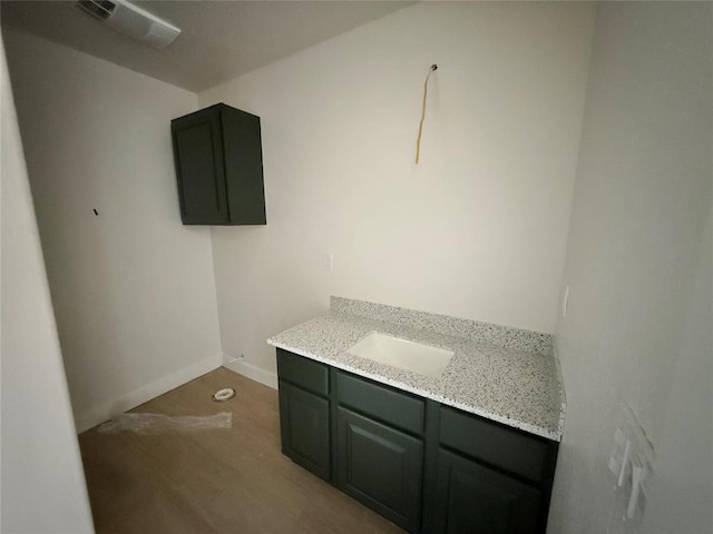 5 Old Glory Ave, Altus, OK 73521 - bathroom featuring vanity, wood finished floors, and baseboards