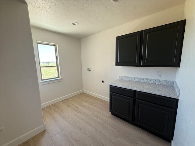 5 Old Glory Ave, Altus, OK 73521 - spare room with a textured ceiling, baseboards, and light wood-style floors