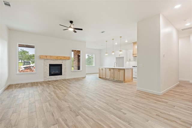 3000 Road Runner Ct, Guthrie, OK 73044 - unfurnished living room with light wood-type flooring, a ceiling fan, baseboards, and recessed lighting