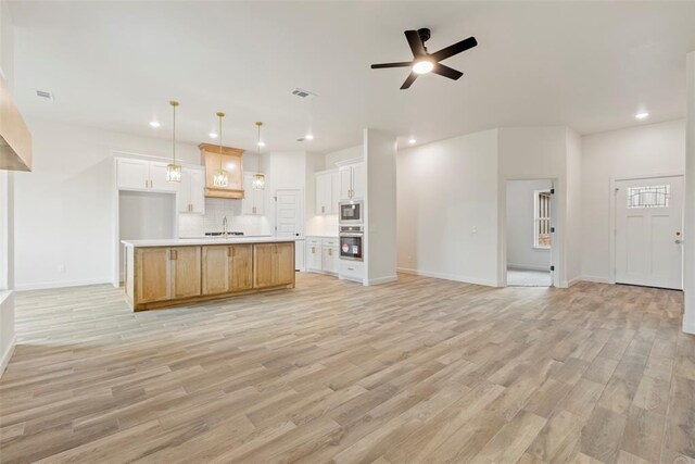 3000 Road Runner Ct, Guthrie, OK 73044 - kitchen featuring open floor plan, a sink, appliances with stainless steel finishes, tasteful backsplash, and recessed lighting
