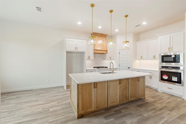 3000 Road Runner Ct, Guthrie, OK 73044 - kitchen with appliances with stainless steel finishes, a sink, backsplash, light wood-style floors, and light countertops