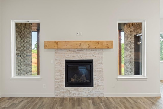 3000 Road Runner Ct, Guthrie, OK 73044 - detailed view of wood finished floors, a glass covered fireplace, and baseboards
