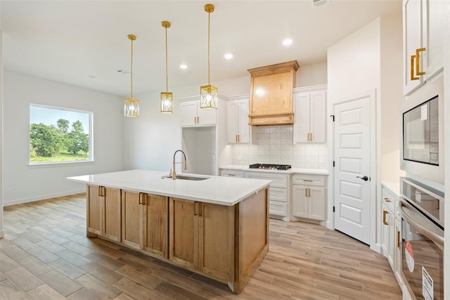 3000 Road Runner Ct, Guthrie, OK 73044 - kitchen with a sink, stainless steel appliances, tasteful backsplash, light wood-type flooring, and light countertops