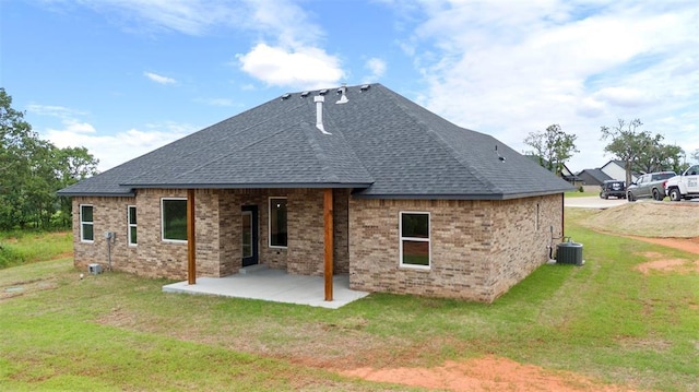 3000 Road Runner Ct, Guthrie, OK 73044 - rear view of house with a patio, a lawn, roof with shingles, and central air condition unit