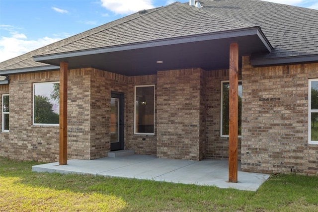 3000 Road Runner Ct, Guthrie, OK 73044 - rear view of house with a patio area, a shingled roof, brick siding, and a lawn